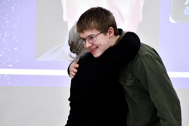 A young person being congratulated at the ceremony.