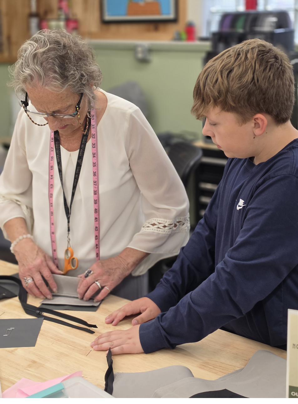 A CES mentor teaching a young person one-on-one.