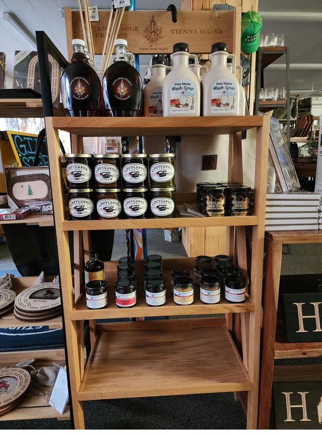 Maple syrup and Maine goods on a shelf.