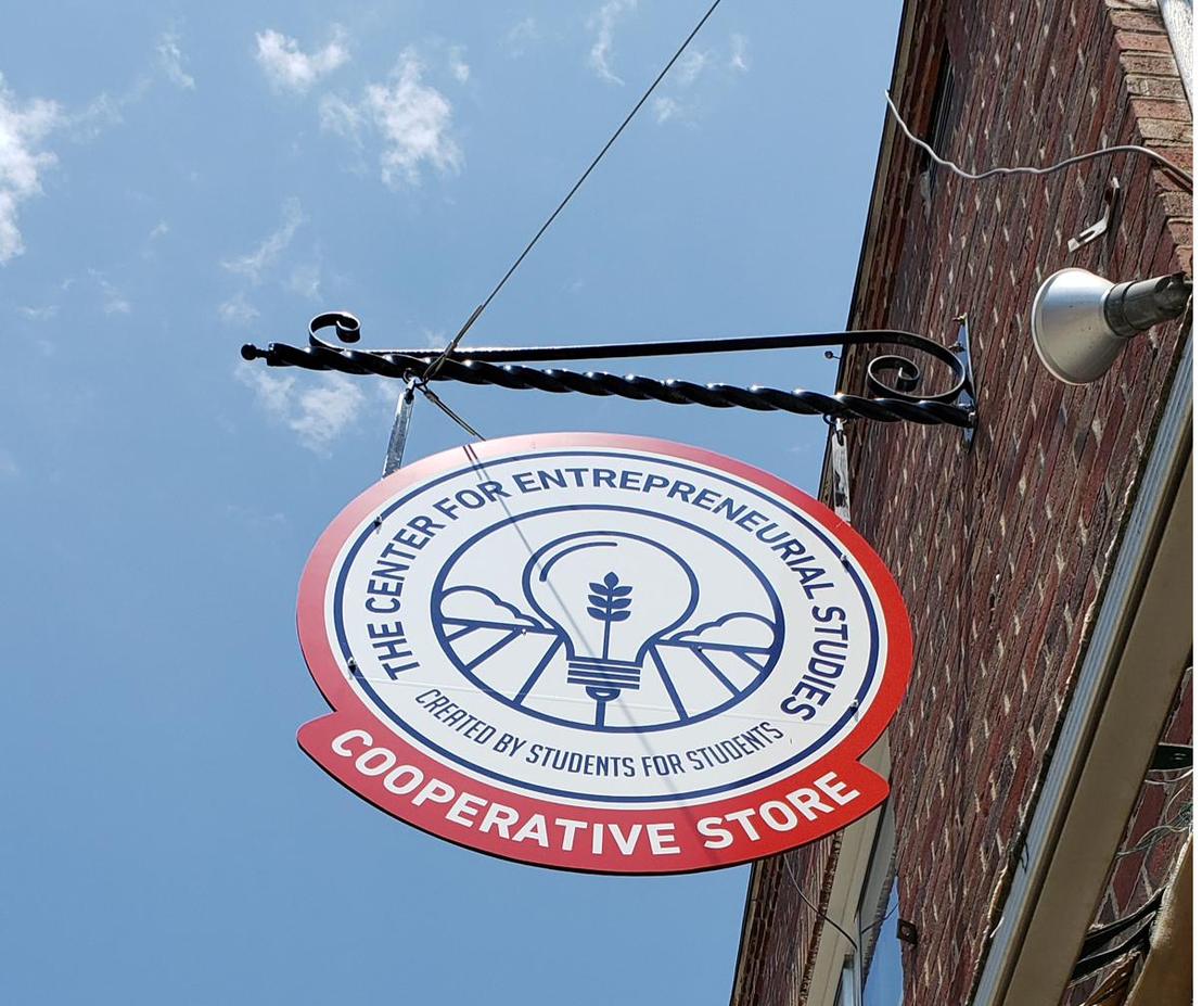 The Center for Entrepreneurial Studies cooperative store sign hanging outside 156 Main Street.