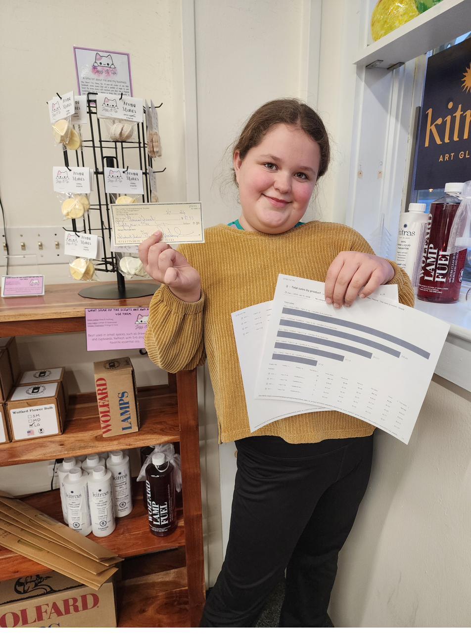 A young person at CES holding up paperwork.